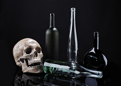 skull beside clear glass bottle thumbnail