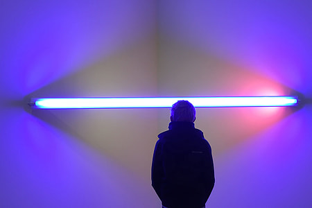 A man stands by abstract lights thumbnail