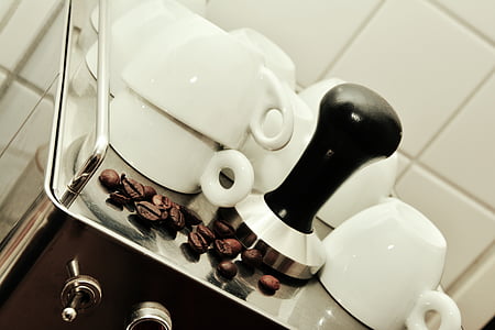 white ceramic mugs beside coffee beans thumbnail