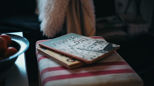 two books on white and red striped ottoman thumbnail