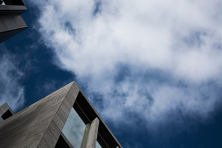 low angle photography of building under white sky thumbnail