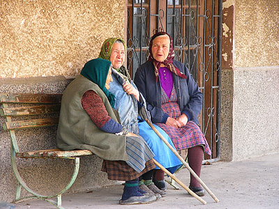 three women sitting on bench near wall thumbnail