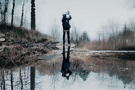 person standing near body of water at daytime thumbnail