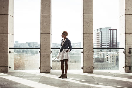 woman standing near wall with window thumbnail