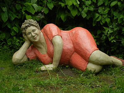 woman wearing red dress laying down garden statue thumbnail