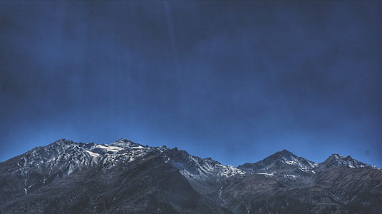 snow-covered mountain under blue sky thumbnail
