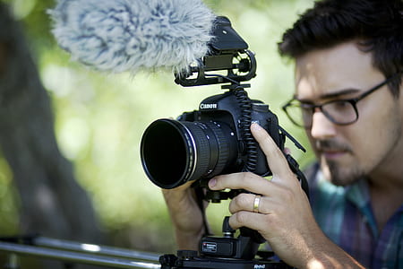 person using black DSLR camera during daytime thumbnail