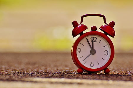 red twin bell analog clock at 11:55 thumbnail