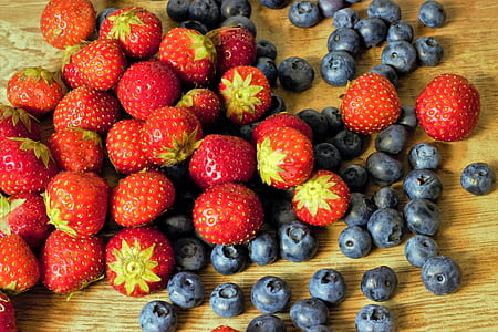 strawberries and blueberries on wooden surface thumbnail