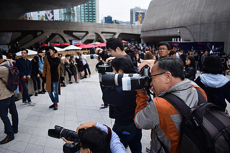 man wearing jacket while taking photo thumbnail