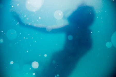 photography of woman under water thumbnail