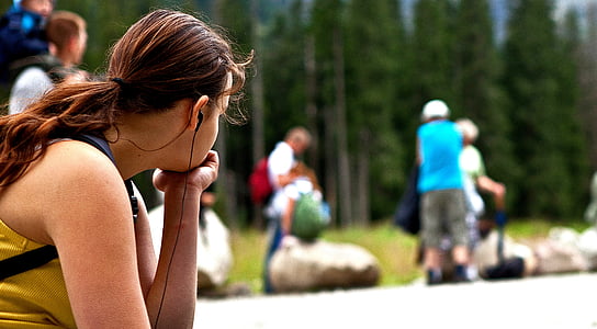 woman wearing yellow top and black earphones thumbnail