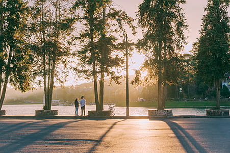 Two People Standing Near Body Of Water thumbnail