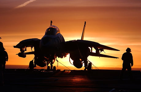 person taking photo of white jet in silhouette thumbnail
