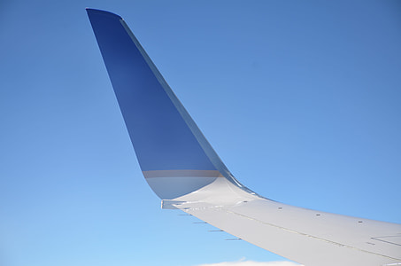 white and blue plane tail close-up photo thumbnail