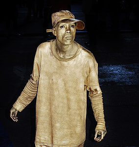 man with gold paint on a dark place thumbnail