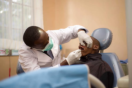 dentist fixing teeth of man thumbnail