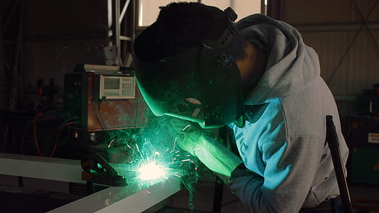 man in gray hoodie doing welding thumbnail
