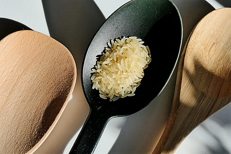 rice grains on black spoon thumbnail
