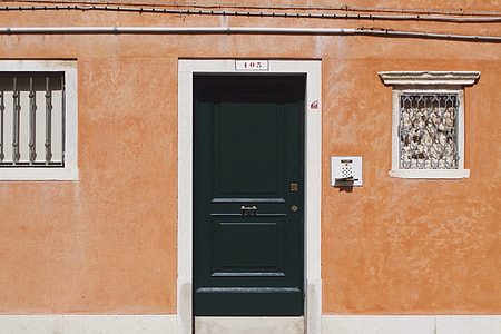 closed green wooden door thumbnail