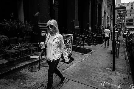 woman walking beside building thumbnail
