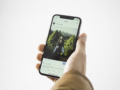 person holding space gray iPhone X thumbnail