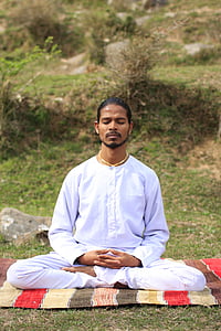 meditating man near on grass field thumbnail