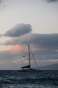 white and brown boat on body of water thumbnail