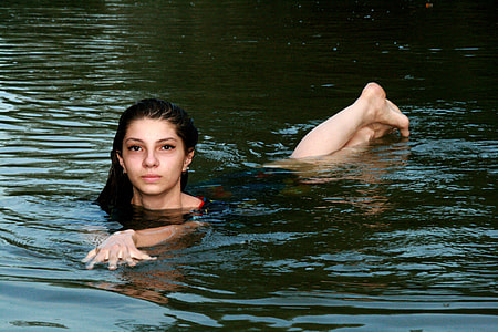 woman in body of water during daytime thumbnail