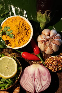spice powder, lemon, chilli pepper, garlic bulb, and sliced of onion thumbnail