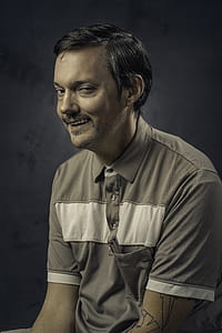 smiling man wearing polo shirt thumbnail