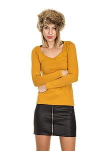 woman wearing yellow scoop-neck long-sleeved shirt and black leather skirt thumbnail