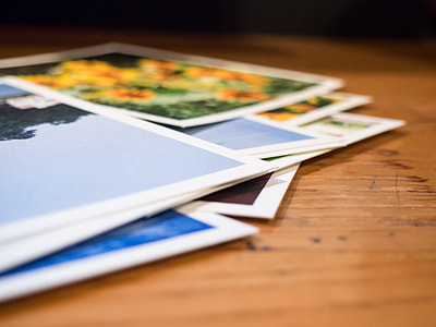 photographs on brown wooden table thumbnail