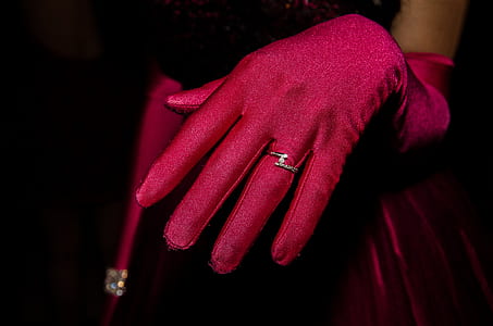 person wearing red gloves and silver-colored ring thumbnail