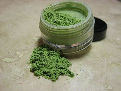 container filled with green powder thumbnail