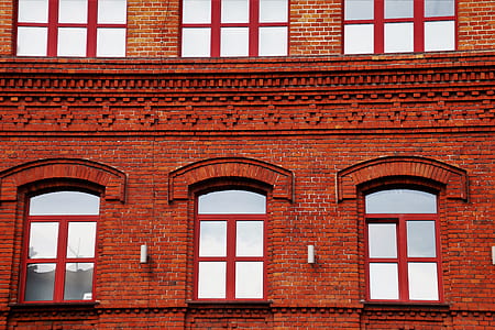 brown bricks building wall with glass window at daytime thumbnail