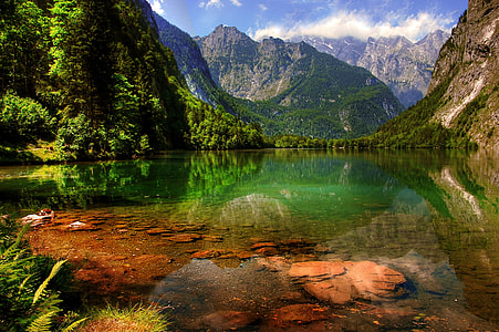 photo of mountain near body of water during daytime thumbnail