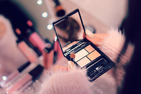 selective focus of person holding makeup kit thumbnail