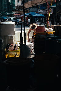 man wearing brown straw hat holding white box thumbnail
