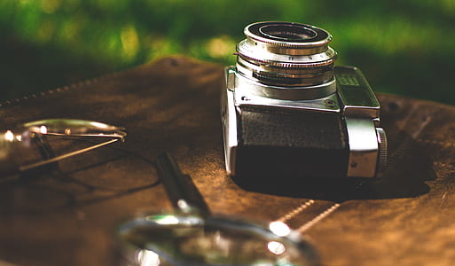 black and gray camera on brown surface thumbnail