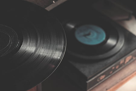 closeup photo of black vinyl record near turntable thumbnail