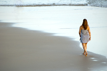 woman in gray sleeveless dress walking on white surface thumbnail