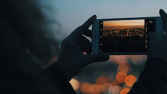 person taking a photo of high-rise buildings thumbnail