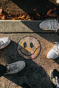 two pairs of gray shoes on gray concrete ground thumbnail
