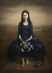 woman wearing floral dress sitting on chair beside bird in middle of field painting thumbnail