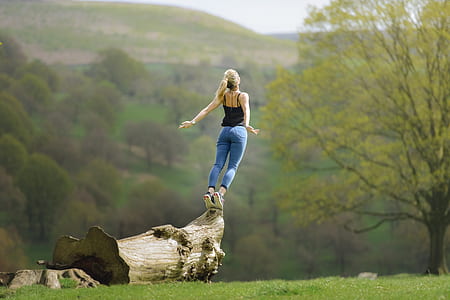 woman standing on brown wood at daytime thumbnail