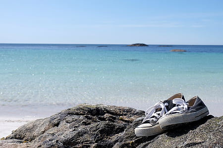 pair of sneakers on top of rock thumbnail