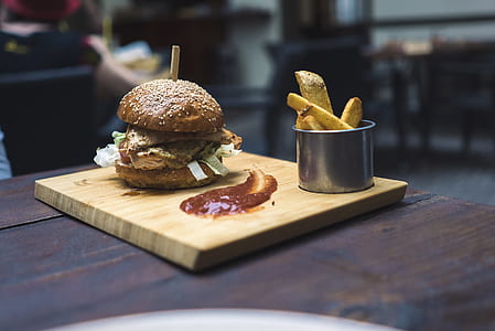 burger on brown wooden platter thumbnail