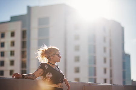 woman leaning on white wall thumbnail