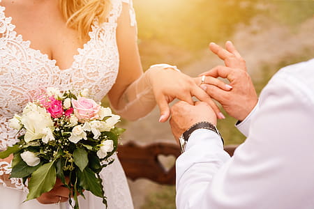 Close up Groom Put the Wedding Ring on bride. Romantic atmosphere thumbnail